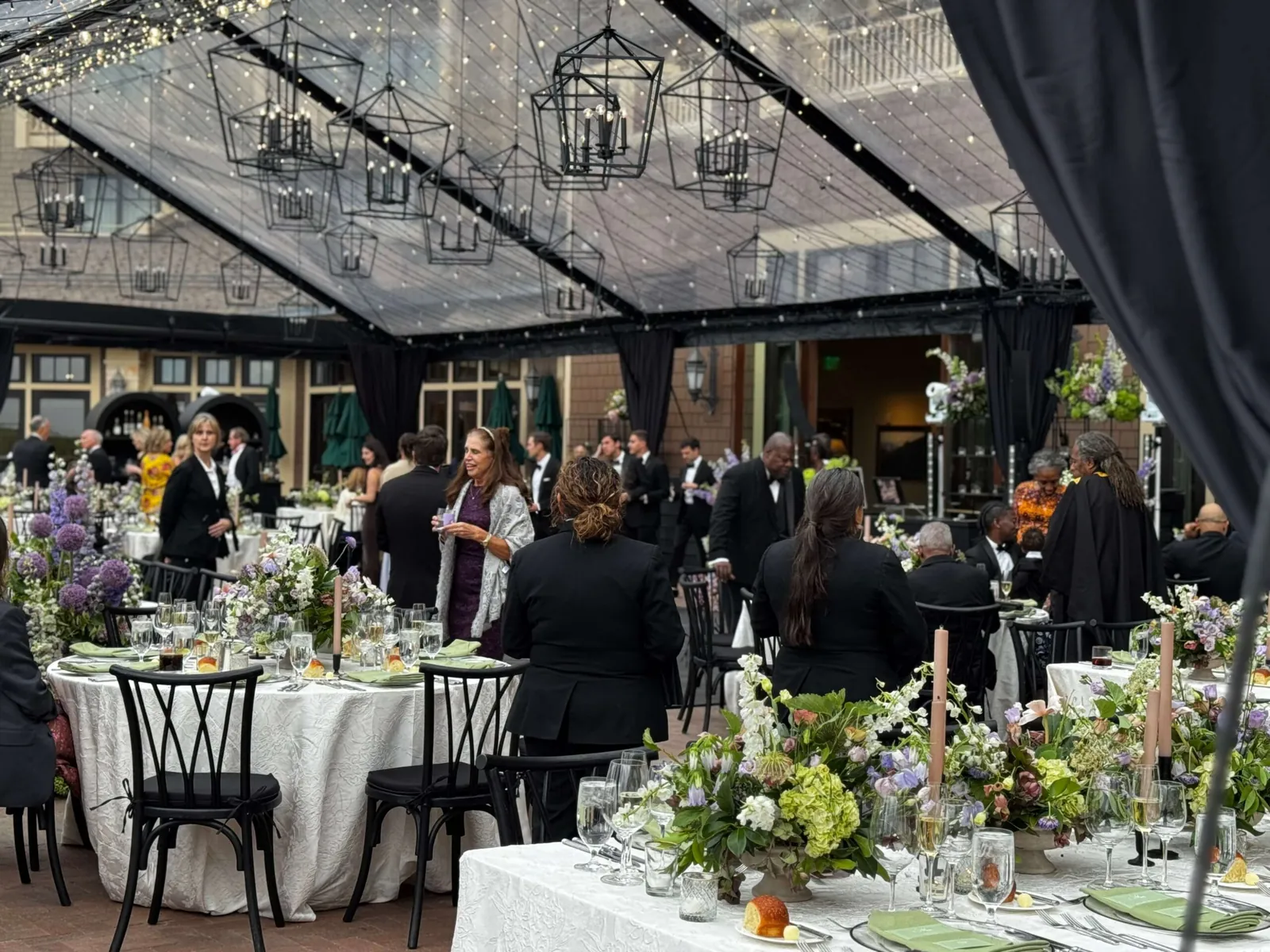 Corporate dinner under chandeliers and glass