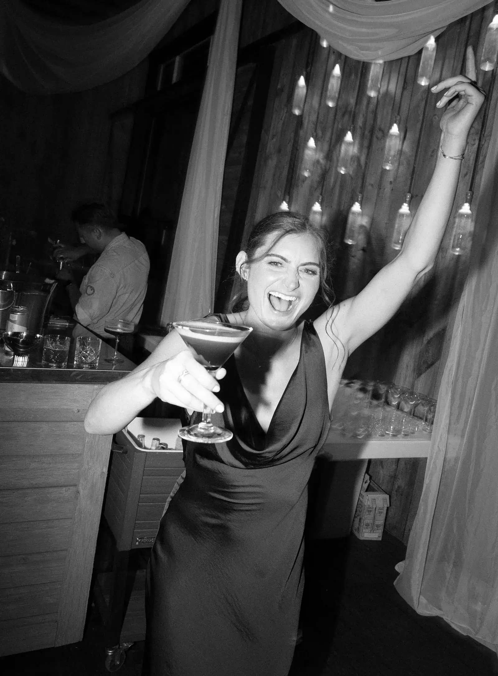 Guest dancing with a martini, black and white